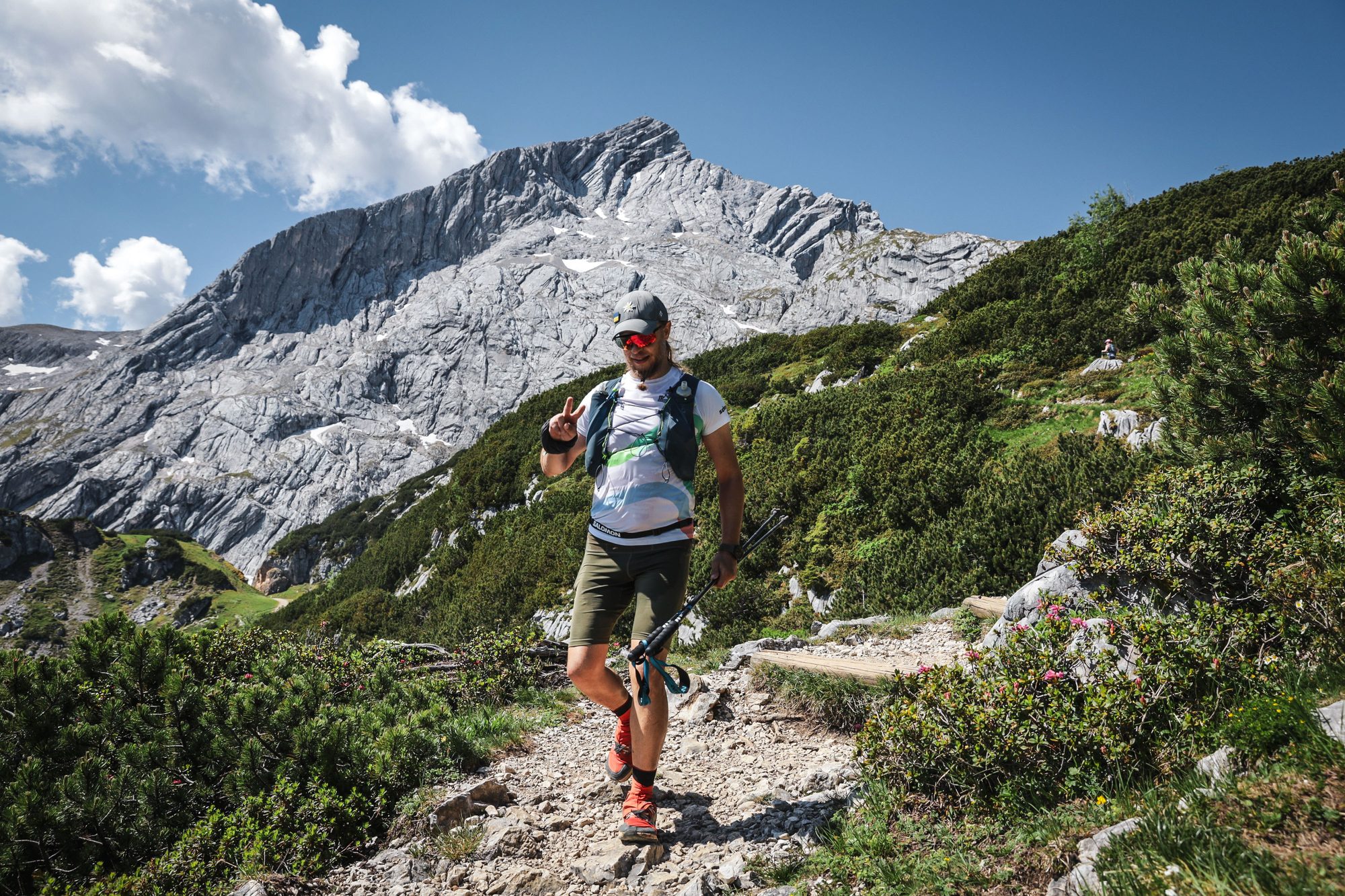 Juhani running through an alpine wildflower meadow