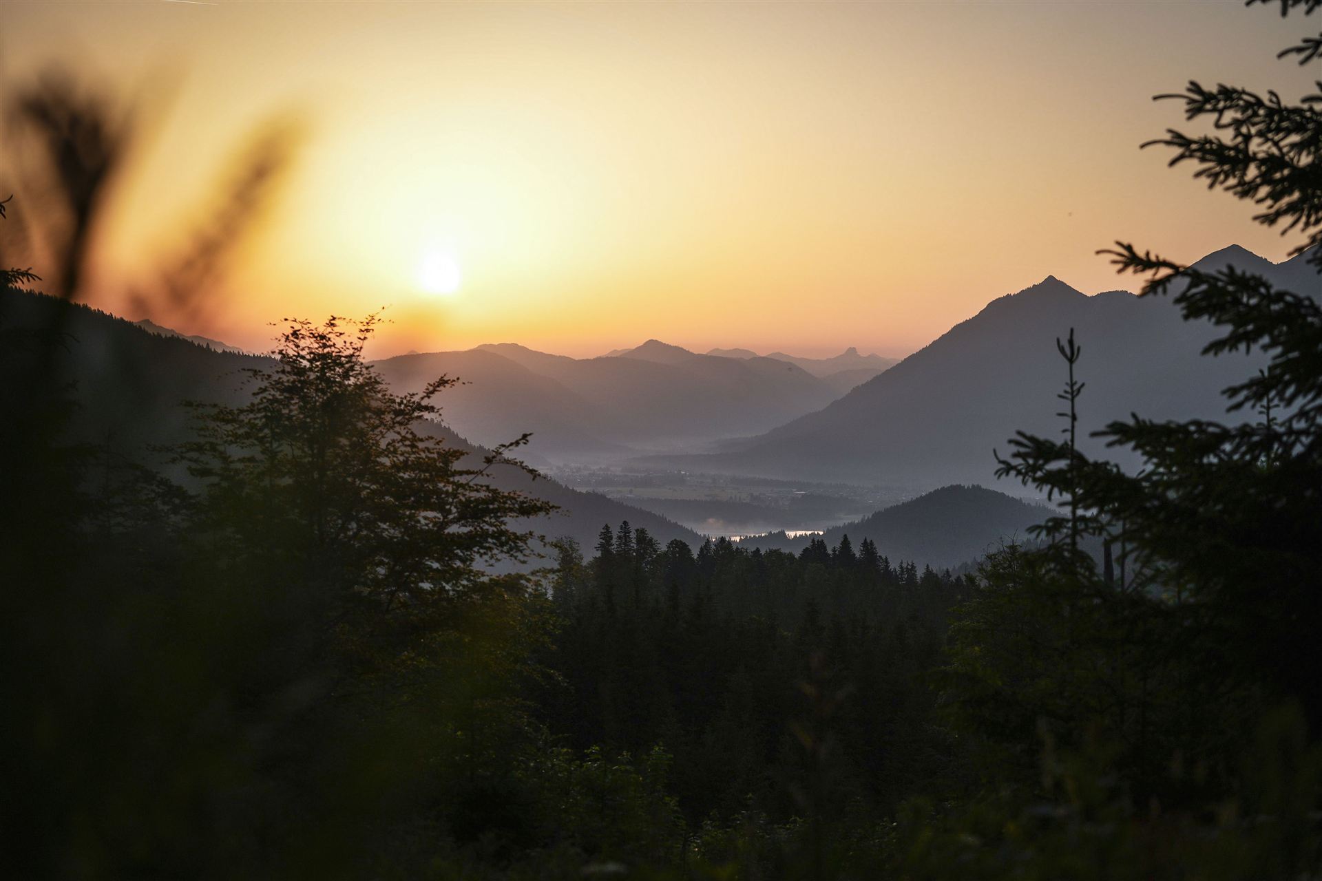 Sunrise over misty alpine valleys at an early morning race start